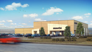 Contemporary commercial building with parking lot, greenery, under bright blue sky.