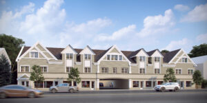 Modern mixed-use building with gabled roofs, large windows, storefronts, and landscaped greenery.