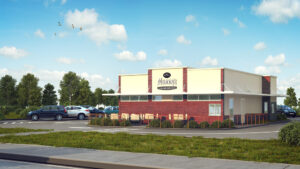 Modern fast-food restaurant with drive-thru, parking, lush landscaping, under sunny skies.